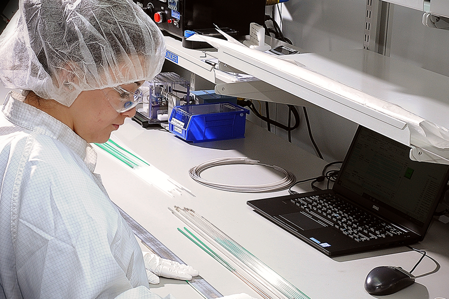 An SPG extrusion expert manufacturing catheter extrusions in a clean work area