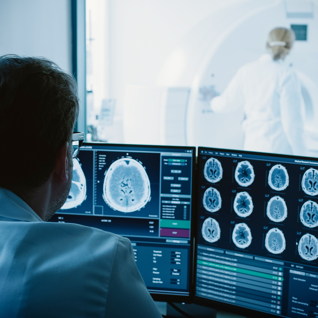 A neurovascular specialist reviews computerized scans of the human brain